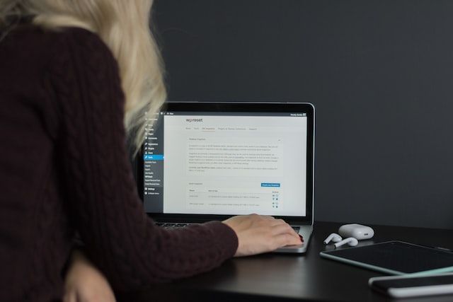 Person working on a computer, looking at a WordPress UI